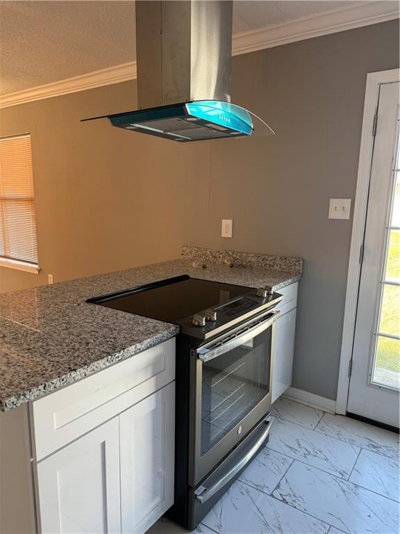 kitchen featuring stainless steel range with electric cooktop, white cabinetry, light stone countertops, light tile flooring, and island range hood