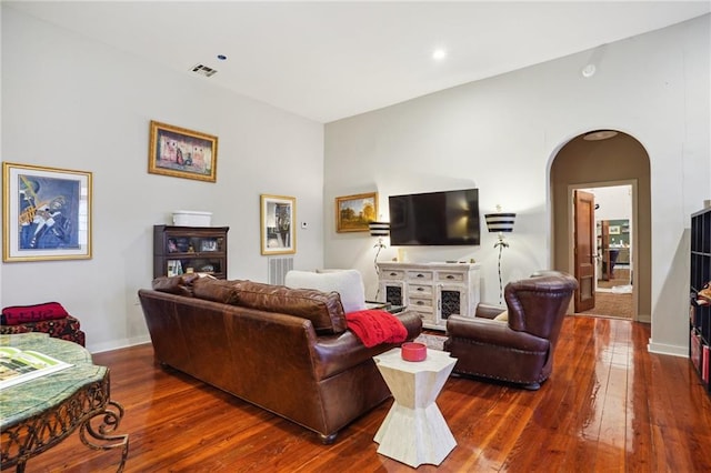 living room with dark hardwood / wood-style flooring