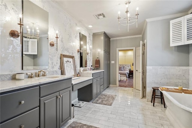 bathroom featuring ornamental molding, tile walls, a washtub, a chandelier, and dual bowl vanity