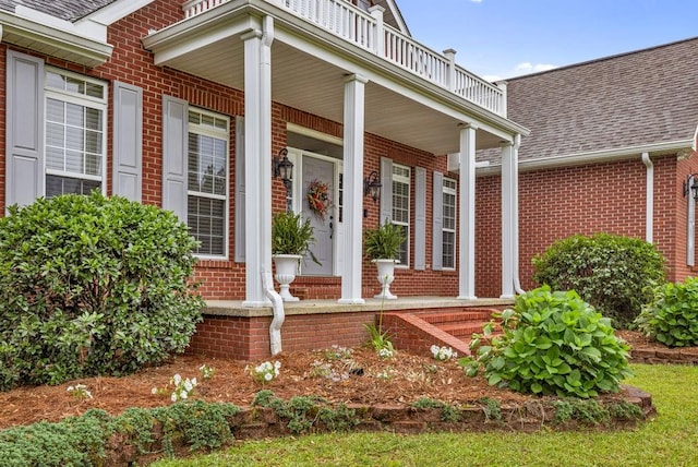 view of exterior entry featuring covered porch