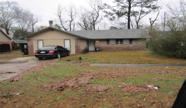 ranch-style house with a front lawn