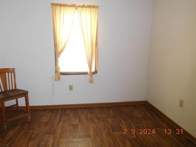 spare room featuring dark wood-type flooring