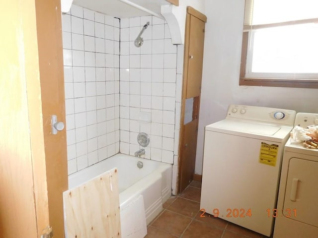 bathroom with tiled shower / bath combo, tile floors, and washer and dryer