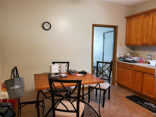 dining area featuring light tile floors