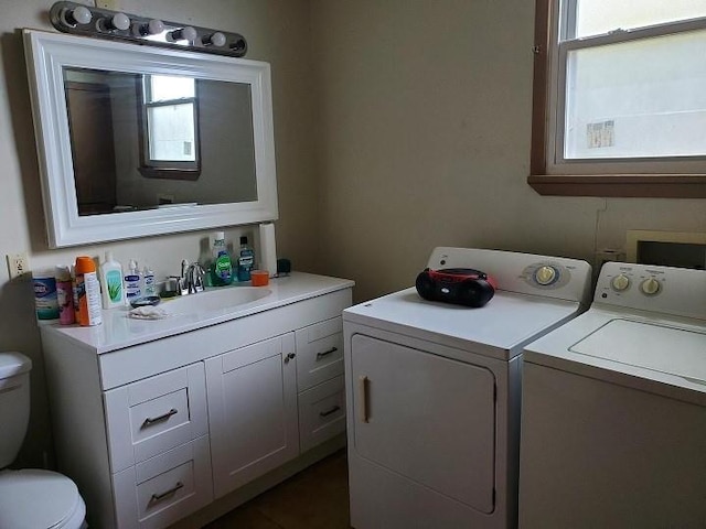 washroom featuring washer hookup, sink, and washing machine and dryer