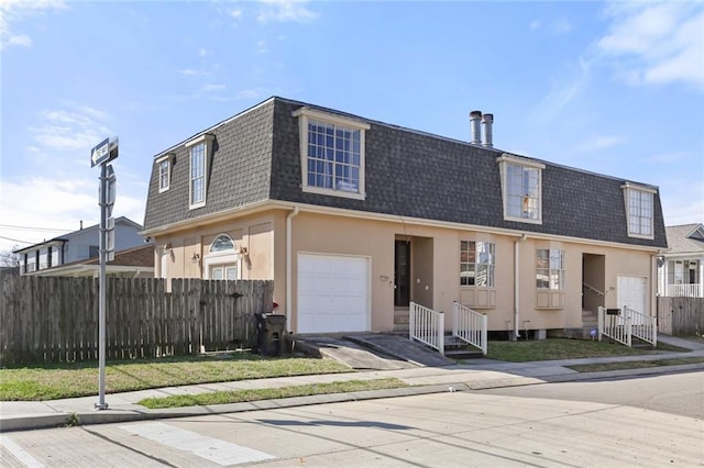 300-02 33rd St, New Orleans, LA 70124 - view of front of house with mansard roof, roof with shingles, and stucco siding