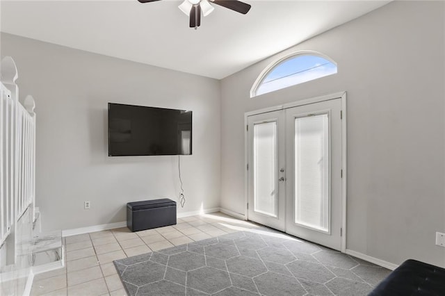 unfurnished living room with french doors, light tile patterned floors, and ceiling fan