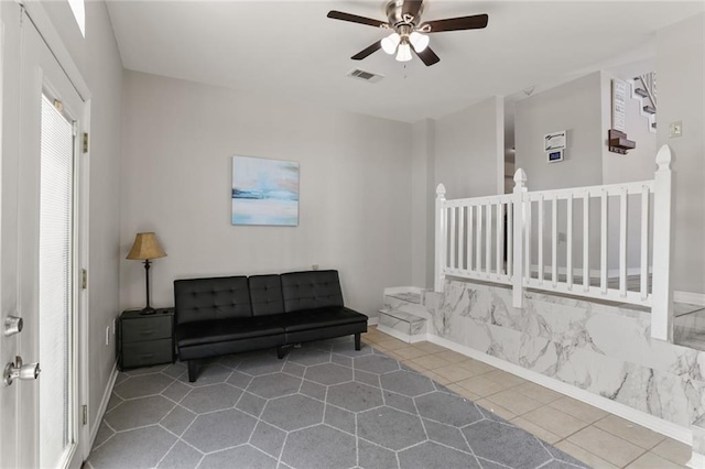 sitting room featuring tile patterned floors and ceiling fan