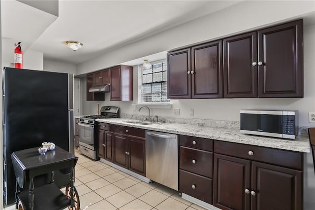 kitchen featuring appliances with stainless steel finishes, dark brown cabinets, sink, and light tile patterned flooring