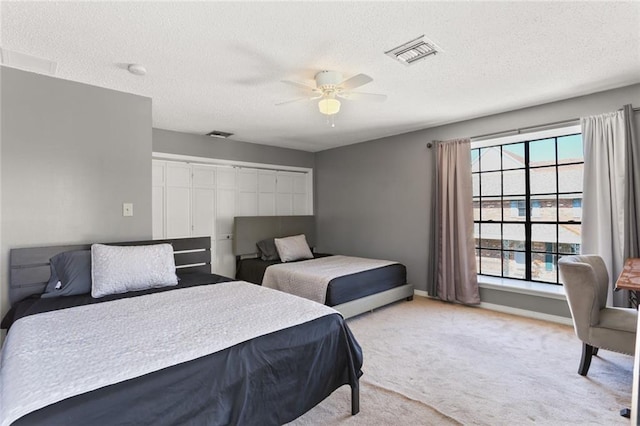 bedroom featuring a textured ceiling, multiple windows, and ceiling fan