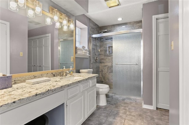 bathroom featuring walk in shower, tile patterned floors, vanity, and toilet