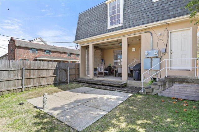 300-02 33rd St, New Orleans, LA 70124 - back of property featuring roof with shingles, mansard roof, a patio, and a wooden deck