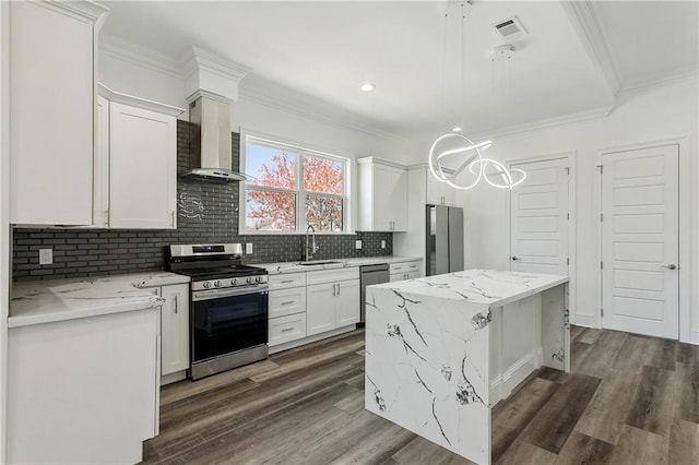 kitchen with light stone countertops, white cabinetry, dark hardwood / wood-style floors, appliances with stainless steel finishes, and wall chimney exhaust hood