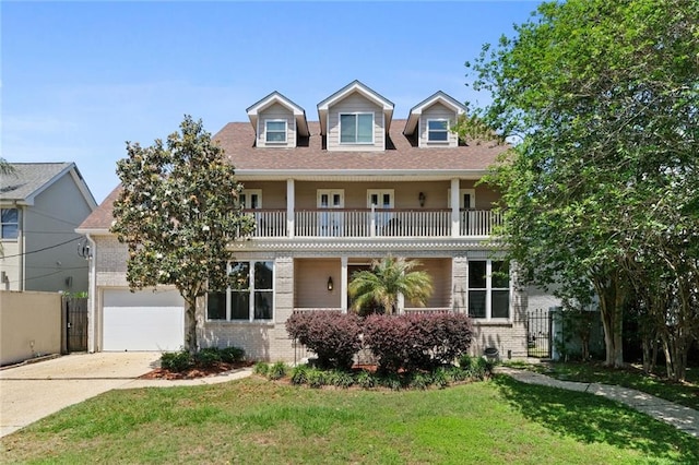 cape cod-style house featuring a balcony, a garage, and a front yard