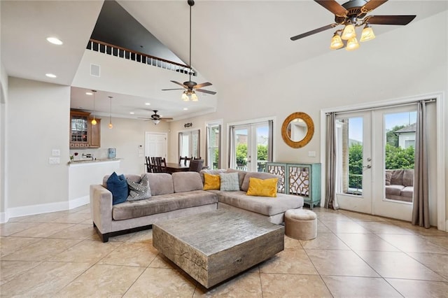 tiled living room with high vaulted ceiling and french doors