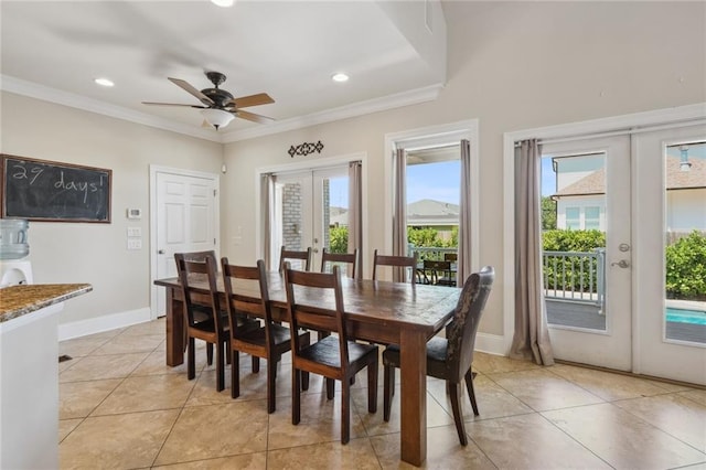 tiled dining room with crown molding, ceiling fan, and french doors