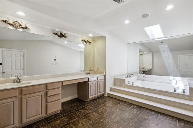 bathroom featuring vanity, lofted ceiling with skylight, and a bathing tub