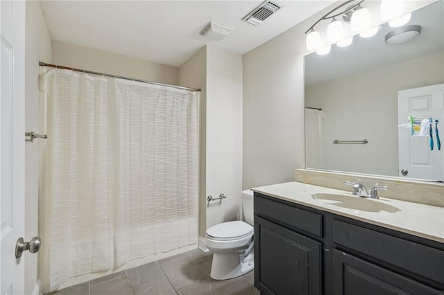 bathroom with vanity, curtained shower, and toilet