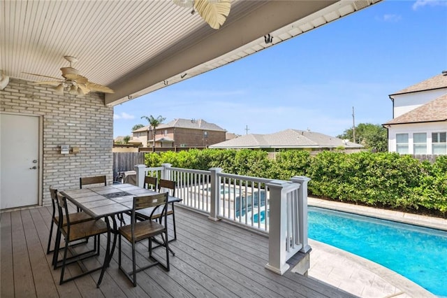 wooden terrace featuring a fenced in pool and ceiling fan