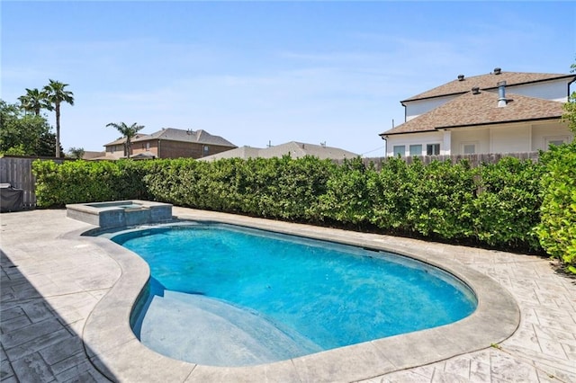 view of pool featuring a patio and an in ground hot tub