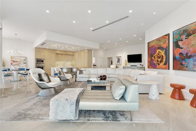 tiled living room featuring an inviting chandelier