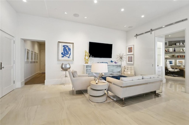 living room with a barn door and light tile flooring