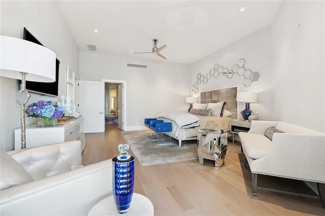 living room featuring light hardwood / wood-style floors and ceiling fan