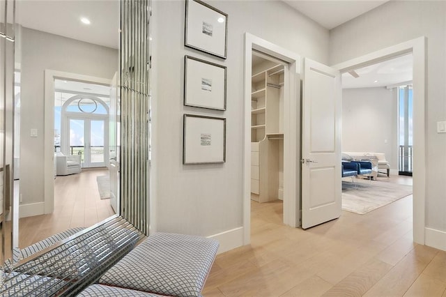 hallway featuring light hardwood / wood-style floors and french doors