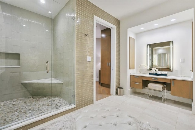 bathroom with oversized vanity, an enclosed shower, and tile flooring