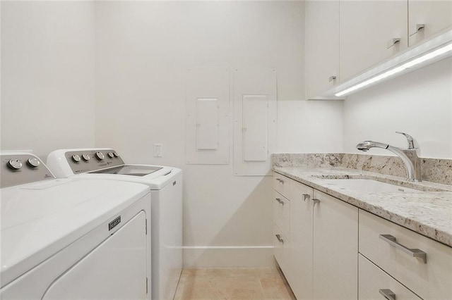 washroom featuring light tile floors, sink, cabinets, and independent washer and dryer