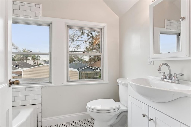 bathroom featuring plenty of natural light, oversized vanity, tile floors, and lofted ceiling