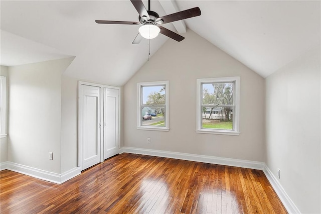 additional living space with dark hardwood / wood-style flooring, ceiling fan, and vaulted ceiling