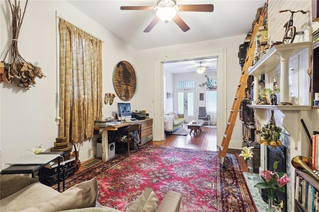 living room featuring dark hardwood / wood-style flooring, ceiling fan, and french doors