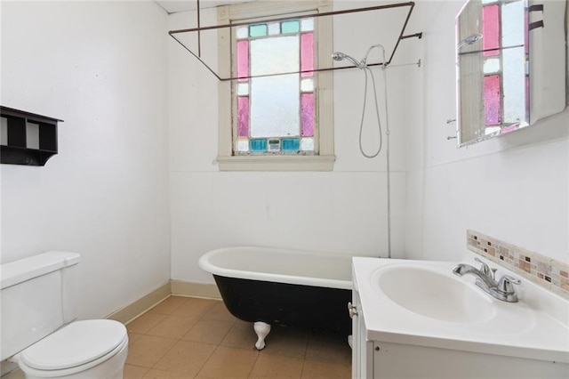 bathroom featuring toilet, vanity, and tile flooring