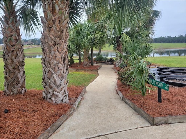 view of property's community featuring a water view and a yard