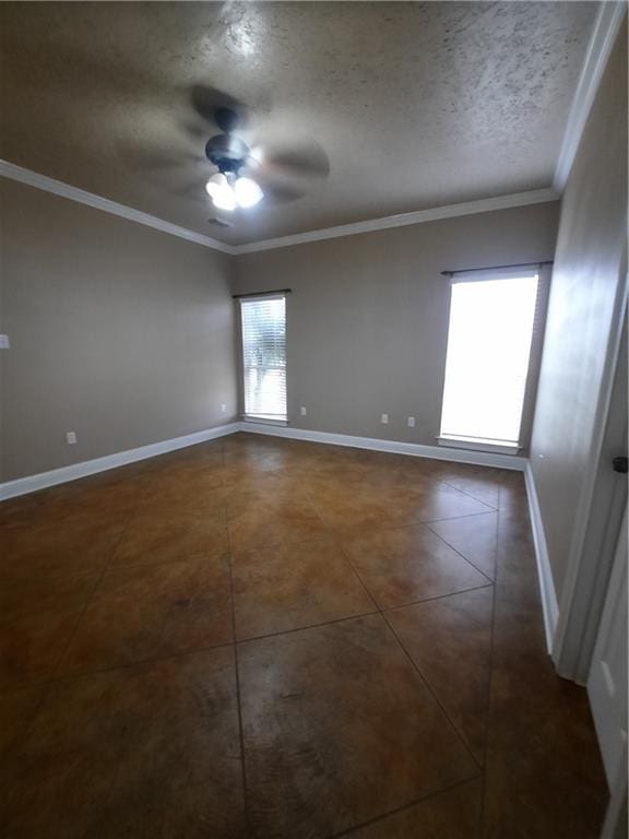 tiled spare room with ceiling fan, a textured ceiling, and crown molding