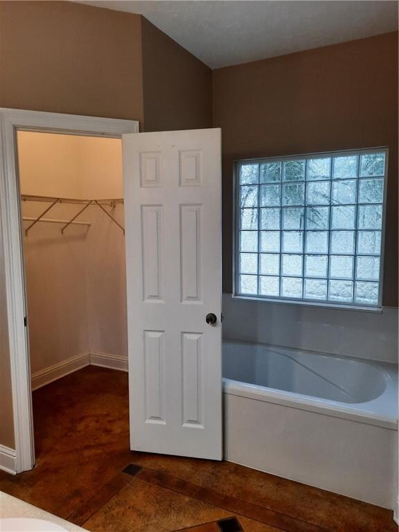 bathroom featuring a bath and hardwood / wood-style floors