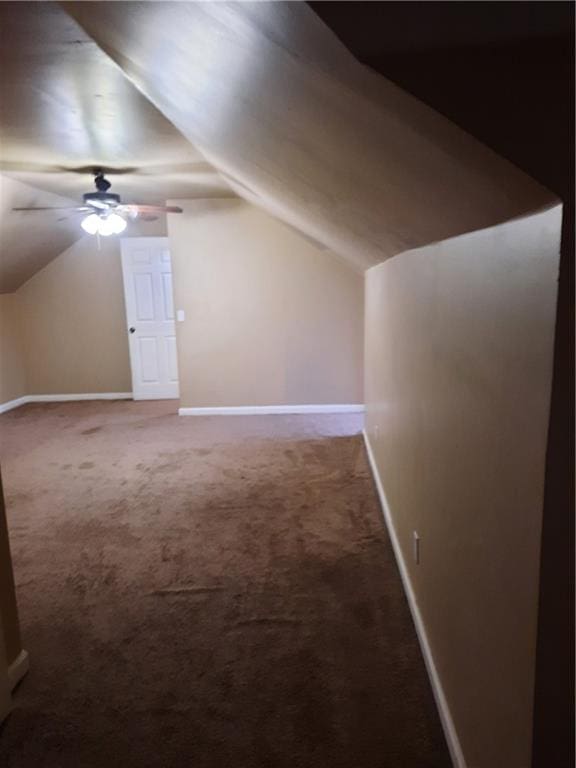 additional living space featuring ceiling fan, vaulted ceiling, and carpet