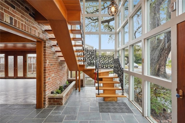 unfurnished sunroom featuring french doors