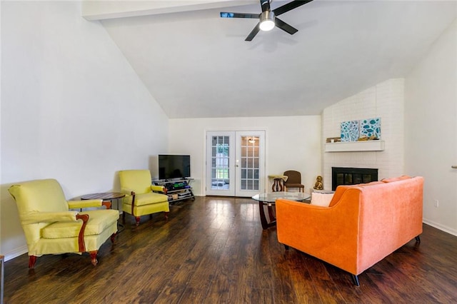 living room featuring dark wood-type flooring, ceiling fan, a fireplace, brick wall, and beam ceiling