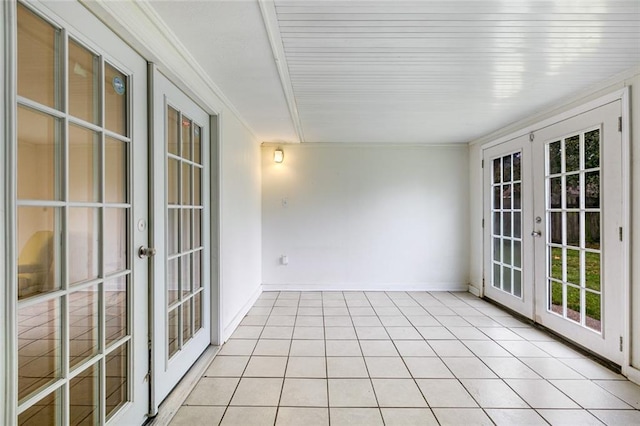 unfurnished sunroom featuring french doors