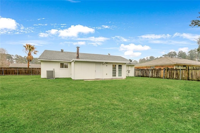 rear view of property featuring a yard