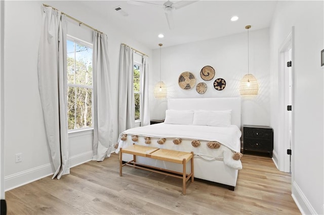 bedroom featuring light hardwood / wood-style flooring and ceiling fan