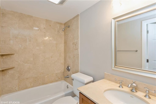 full bathroom with tiled shower / bath, toilet, and vanity