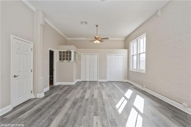 spare room featuring crown molding, wood-type flooring, and ceiling fan