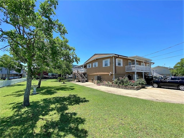 view of front of property with a front lawn and a balcony