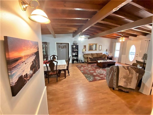 living room with light hardwood / wood-style floors, ceiling fan, and beamed ceiling