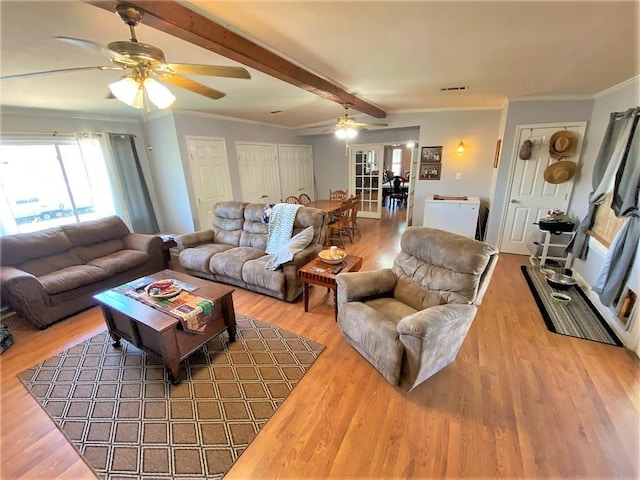 living room with beamed ceiling, hardwood / wood-style floors, ceiling fan, and crown molding