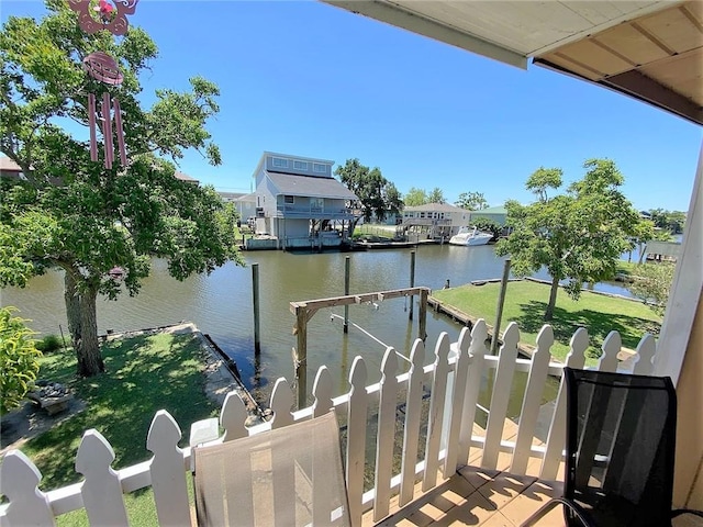 balcony with a boat dock and a water view