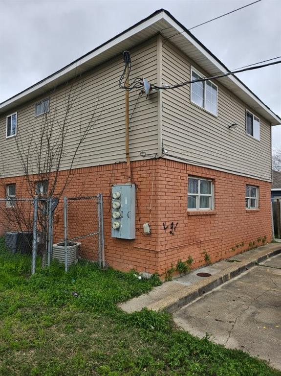 view of side of home featuring central air condition unit